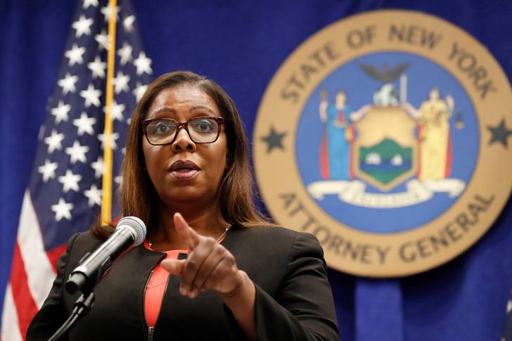 Letitia James stands in front of a flag and a shield for New York State Attorney General